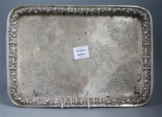 A Persian white metal rectangular tray, engraved and embossed with foliage, birds and figures, 39cm.